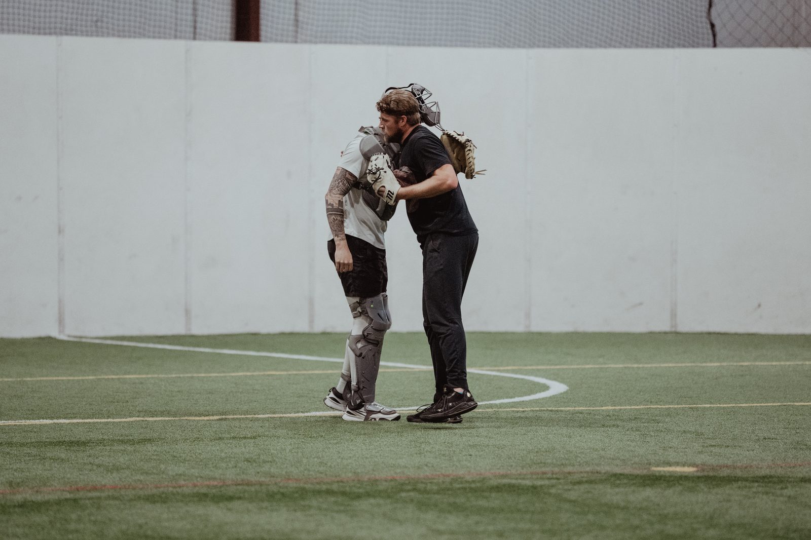 An APEC coach and catcher after a bullpen