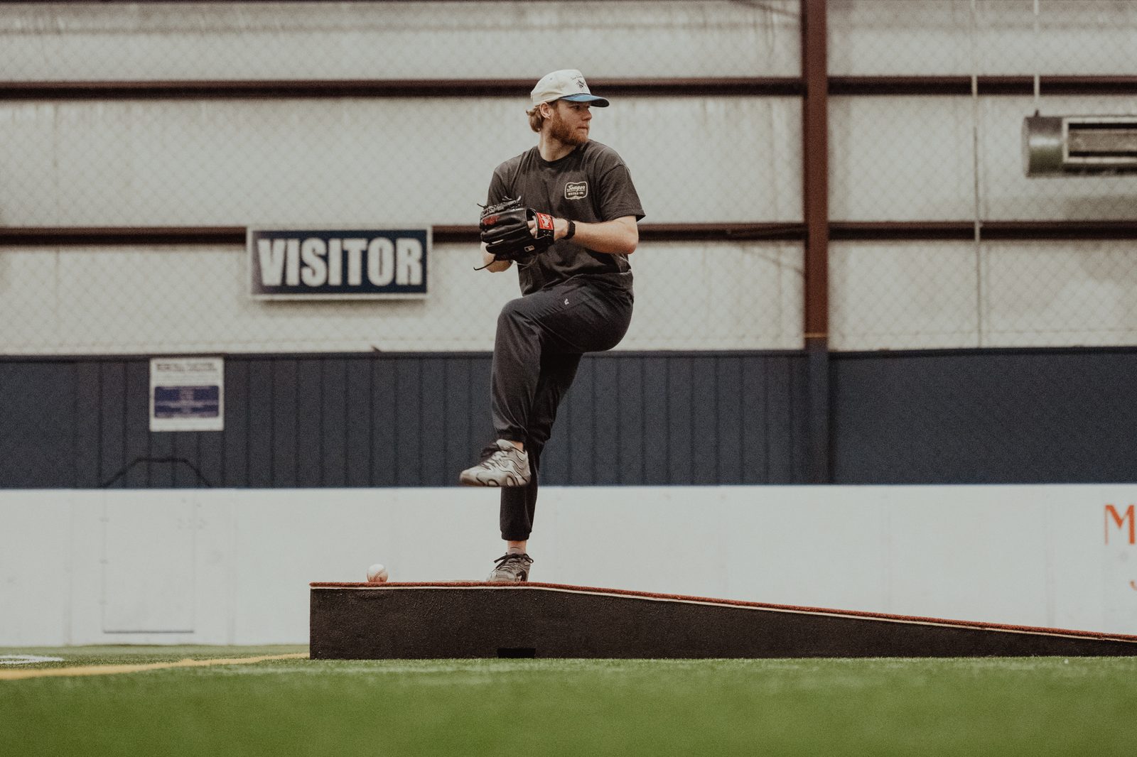 An APEC pitcher at the top of his leg lift