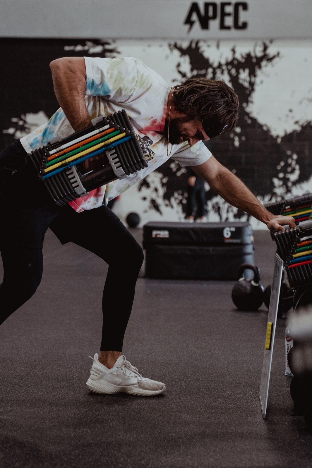 An athlete rowing dumbbells at APEC