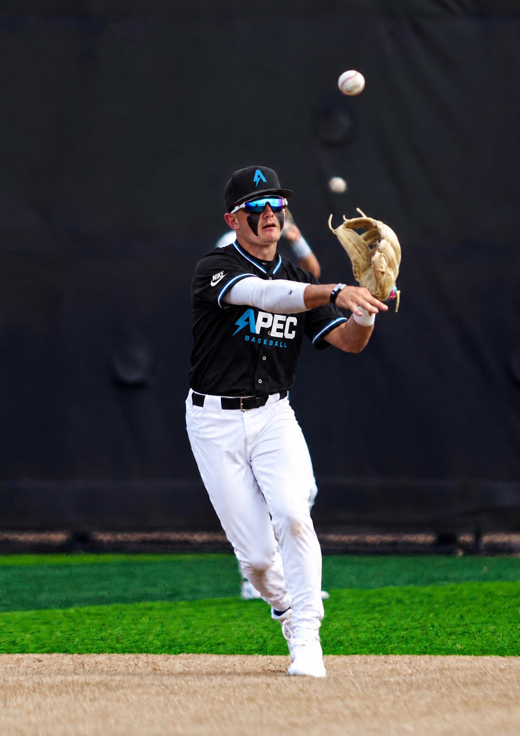 APEC Baseball infielder throwing across the diamond