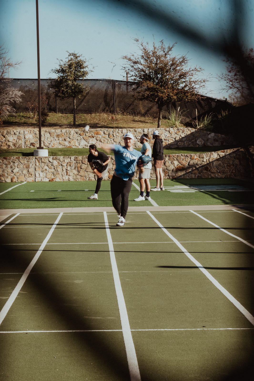 APEC players on the outdoor turf during a throwing progression