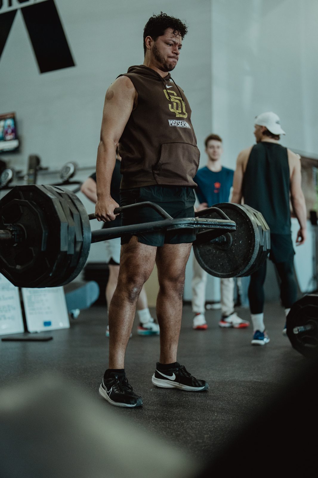 Athlete at lockout on a loaded trap-bar deadlift