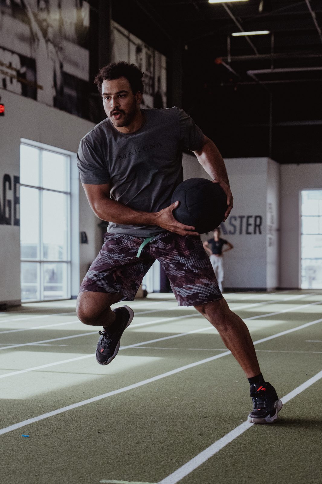 Trent Grisham accelerating with a medicine ball across the APEC turf